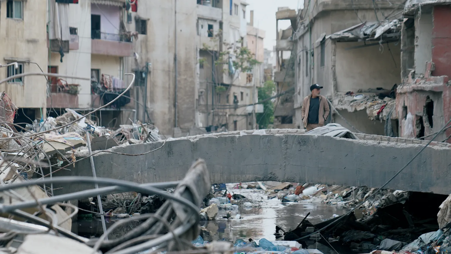 Rubble and debris fill narrow streets of Hay el Sellom following the intensive Israeli air campaign.