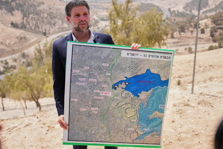 Israeli Finance Minister Bezalel Smotrich displays a map of the E1 settlement project in the occupied West Bank.