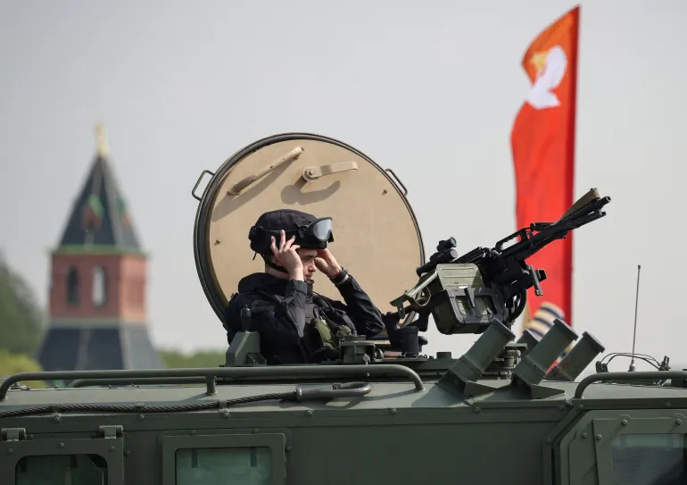 Russian security officer on all-terrain vehicle reflects heightened security measures amid Ukrainian drone threats to Moscow.