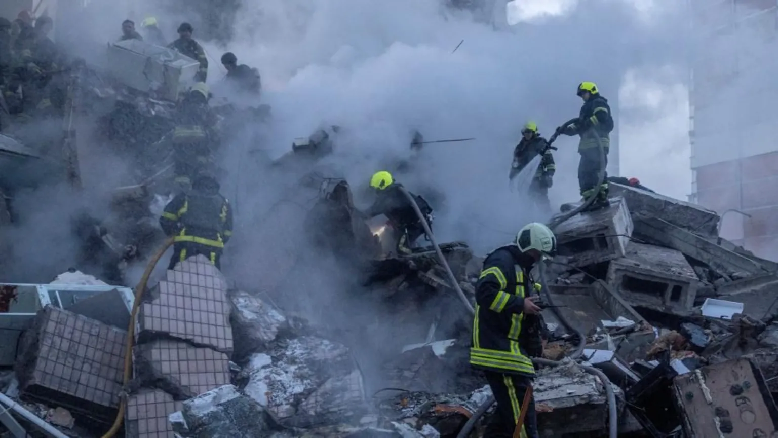 Emergency teams extract survivors from the partially collapsed residential building in Kyiv as search efforts continue.
