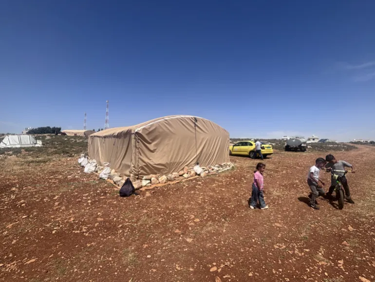 Children from Abu Najjeh's Bedouin community play near tents in Rammun, occupied West Bank.