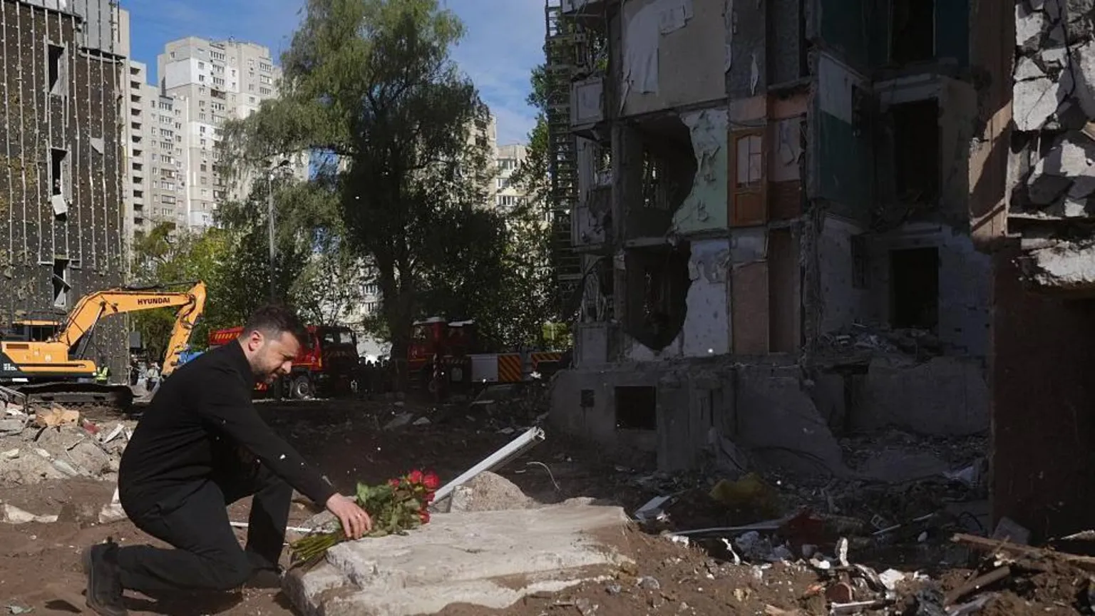 President Zelensky lays flowers at Kyiv residential block struck by Russian cruise missile, killing 24 people.